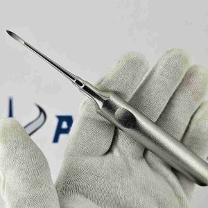 Straight Heidbrink root tip elevator dental instrument held in gloved hand for tooth extraction