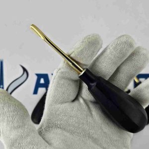 Close-up of dental gloved hand holding a Bein root elevator with straight gold titanium tip