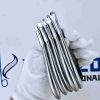 Hand holding set of stainless steel clear aligner pliers for orthodontic dental adjustments.