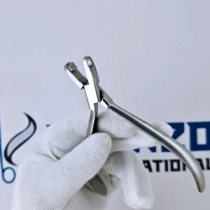 Gloved hand holding orthodontic aligner accent plier for clear tray modification