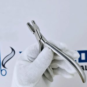 Close-up of stainless steel aligner hole punch plier used in orthodontic treatments