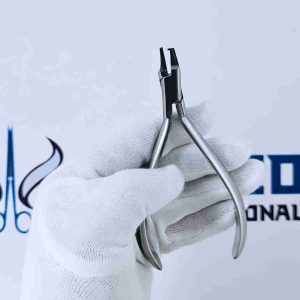 Front close-up of gloved hand holding stainless steel orthodontic pliers.