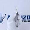 Stainless steel punch hole clear aligner plier held by a gloved hand against an Avenzor International logo.