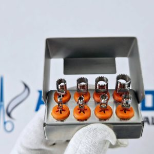 Front view of dental implant trephine drills arranged in labeled orange silicone holders in a metallic cassette.